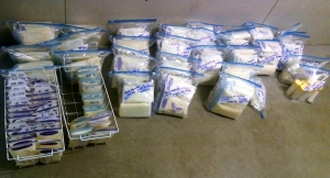 Several dozen packages of frozen breast milk laid out.