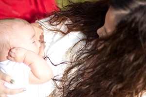 Stephanie's long hair flows around her shoulder's as she breastfeeds.